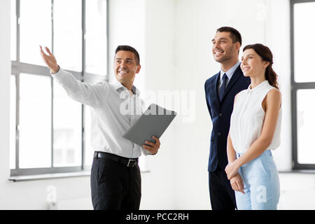 realtor with folder showing customers new office Stock Photo