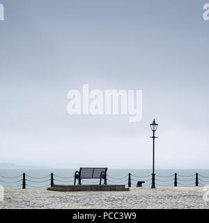 Lonely empty bench seat coastal sea peaceful quiet mindfulness scene view Stock Photo