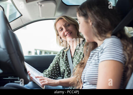 Teenager Having Driving Lesson With Female Instructor Stock Photo
