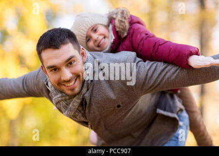 happy father and daughter playing at autumn park Stock Photo