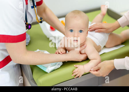 Little cute baby boy visiting doctor . Pediatrician make check up and examining infant for disease prevention protocol. Children healthcare concept Stock Photo