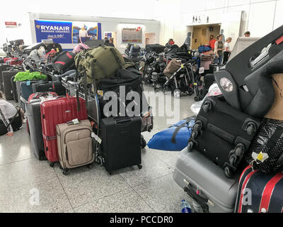 Some of over a thousand abandoned suitcases left at Stansted Airport in Essex on Sunday afternoon waiting to be collected by passengers who lost their luggage in the travel chaos at the