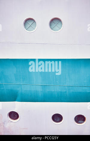 Retro toned close up picture of an old ship side with portholes. Stock Photo