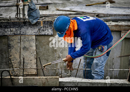 Builder using oxy acetylene torch on a construction site. Thailand Southeast Asia Stock Photo