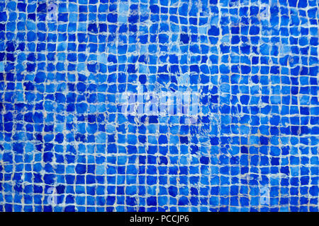 Abstract texture of blue pool mosaic bottom through the ripples of water. Navy geometric cellule background. Stock Photo