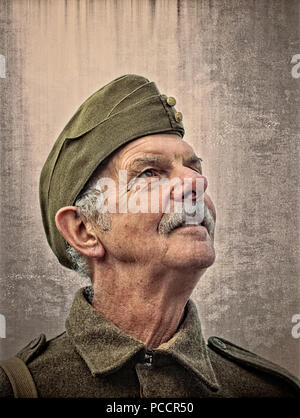 Close portrait of senior male with grey moustache (like Dad's Army character) in military, army uniform at UK 1940s event. Stock Photo