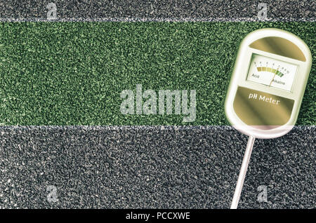 analog soil ph test tool on a dark gray surface - gardening concept Stock Photo