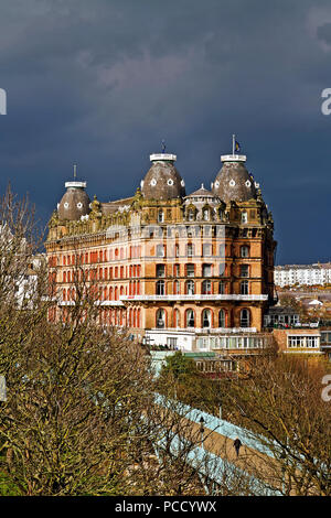 Scarborough’s Grand Hotel, lit by strong afternoon sunlight stands out against a backdrop of gathering storm clouds. Stock Photo