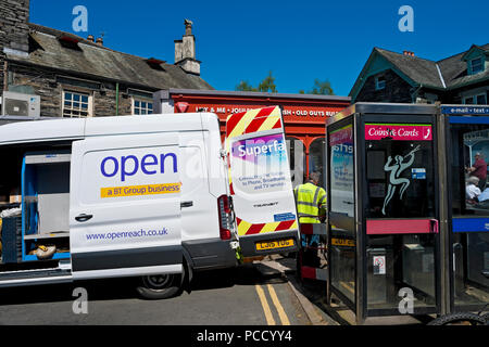 Openreach engineer worker and van outside a telephone phone box Ambleside Cumbria England UK United Kingdom GB Great Britain Stock Photo