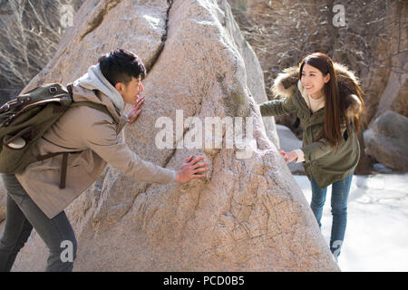 Happy young Chinese couple enjoying winter outing Stock Photo