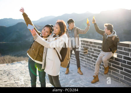 Happy young Chinese friends having fun on the Great Wall Stock Photo