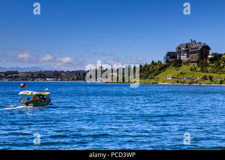 Excursion boat and wooded shoreline, Lake Llanquihue, downtown Puerto Varas, Lakes District, Chile, South America Stock Photo