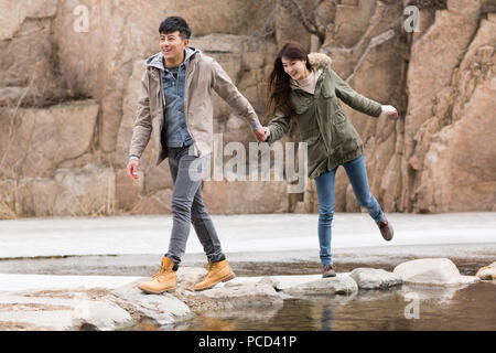 Happy young Chinese couple enjoying winter outing Stock Photo