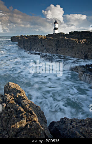 Lighthouse at Penmon Point under clouds, Anglesey, North Wales Stock Photo