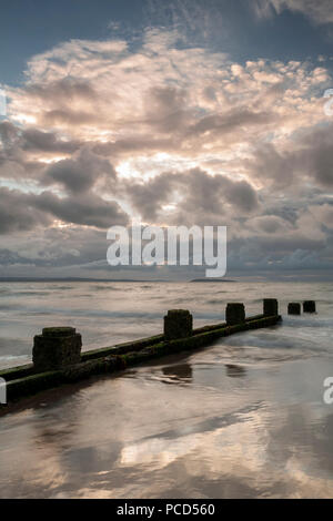 Groynes on the beach at Penmaenmawr on the North Wales coast Stock Photo