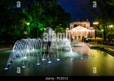 Springtime night long exposure composition at the public garden in front of the Ivan Vazov National Theater, Sofia, Bulgaria. Beautiful fountain in th Stock Photo