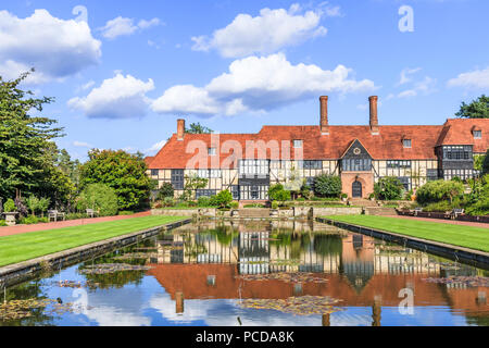 Historic Laboratory Building with reflections in the Jellicoe Canal, an iconic view at the Royal Horticultural Society (RHS) botanical Gardens, Wisley Stock Photo