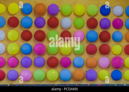 Colored balls on a wooden wall, new design. Stock Photo