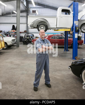 Portrait of a senior caucasian male owner of an antique car repair shop Stock Photo