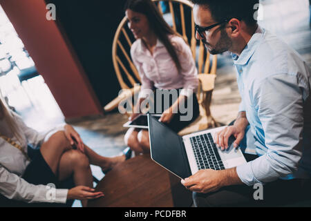 Happy colleagues from work socializing in restaurant Stock Photo