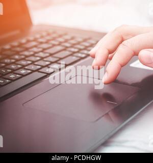 female hand on a laptop, touchpad. work at the computer. notebooks Stock Photo