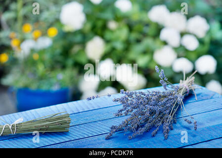 Bunch of lavender on the blue wooden desk. Stock Photo
