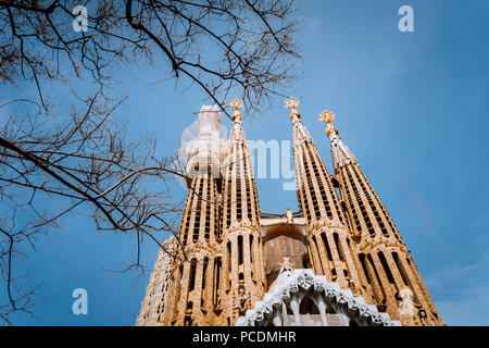 BARCELONA, SPAIN - April 25, 2018: La Sagrada Familia - the impressive cathedral designed by Gaudi, which is being build since 19 March 1882 and plane Stock Photo