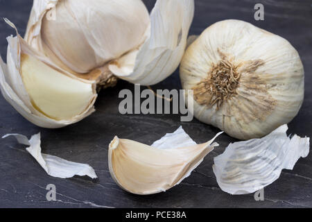 Garlic bulbs with garlic cloves on the wooden background Stock Photo