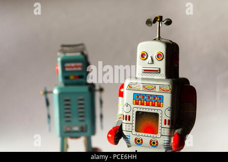 Two vintage tin toy robots, robotic delivery, artificial intelligence concept Stock Photo