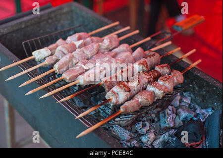 grilling shashlik on a barbecue skewer Stock Photo