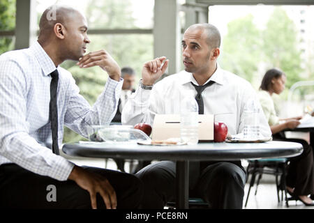 A black businessman and a middle eastern businessman having a business lunch. Stock Photo