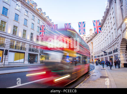 A London Bus traveling along Regent Street, on a late summers evening, blurred as it moves. Stock Photo