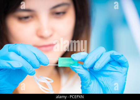technician girl with microfluidic device LOC in microbiological lab Stock Photo