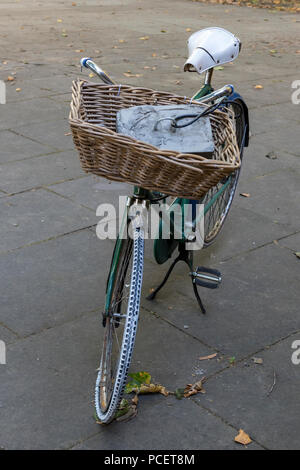 old fashined vintage bakers bike or bicycle with a shopping basket on the front of a delivery bicycle. Stock Photo