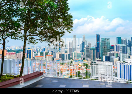 Aerial cityscape of Singapore metropolis from the viewpoint with bench in trees shadow Stock Photo