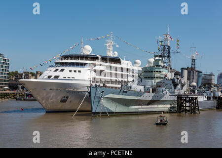 the silversea cruise liner silver wind alongside HMS Belfast on the river thames in central london dressed overall. Stock Photo