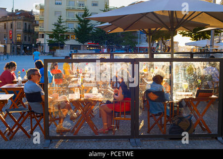 PORTO, PORTUGAL - NOVEMBER 16, 2017: People at a street restaurant at Old Town of Porto. Porto is a second largest city and popular tourist destinatio Stock Photo