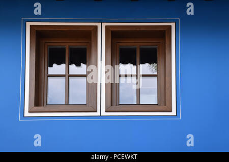Windows on a blue facade of a Bulgarian traditional house Stock Photo