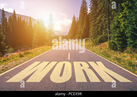Work word written on road in the mountains Stock Photo