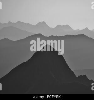 Silhouettes of Mount Tannhorn and other mountains in the Bernese Oberland. View from Mount Brienzer Rothorn. Stock Photo