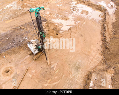 drilling rig standing at the construction site and ready for work. aerial top view Stock Photo