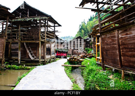 Typical Dong Village,Wooden Houses,Huanggang Dong Village,Dong Costumed Girls,Singing to Students,,Dwellings,Guizjou,PRC,People's Republic of China Stock Photo