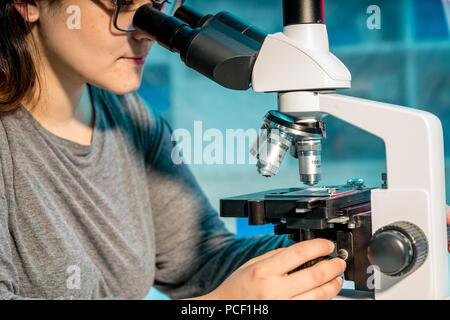Female scientist researcher conducting an experiment in a laboratory Stock Photo