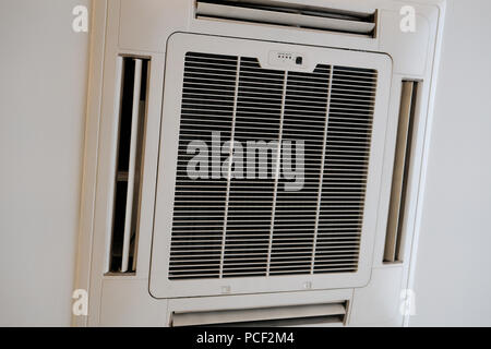 mounted cassette type air conditioner on ceiling. ventilation system Stock Photo