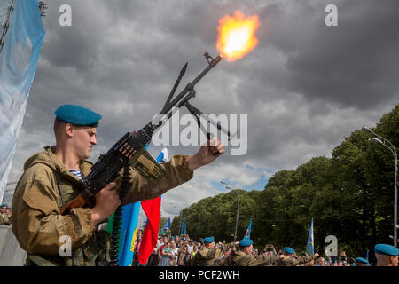 A soldier of the airborne troops fired a machine gun 'Pecheneg' during demonstrations in Gorky Park on the day of the airborne forces, Moscow Stock Photo