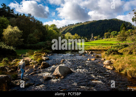 A river winds it's way past church and round tower Stock Photo