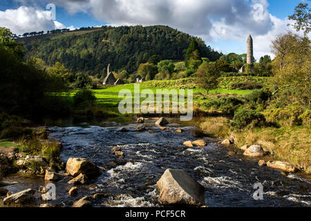 A river winds it's way past church and round tower Stock Photo