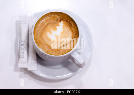 Cup of coffee on a saucer and two sachets of sugar, great design for any purposes. Espresso coffee. Coffee background. Coffee cup isolated. Coffee clo Stock Photo