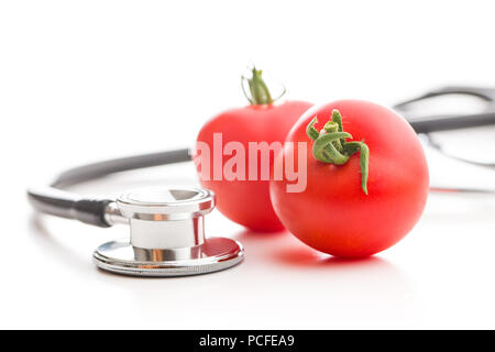 Red tomatoes and stethoscope isolated on white background. Stock Photo