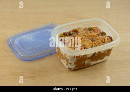 Frozen beef chili leftovers thawing in plastic storage container for easy quick dinner Stock Photo